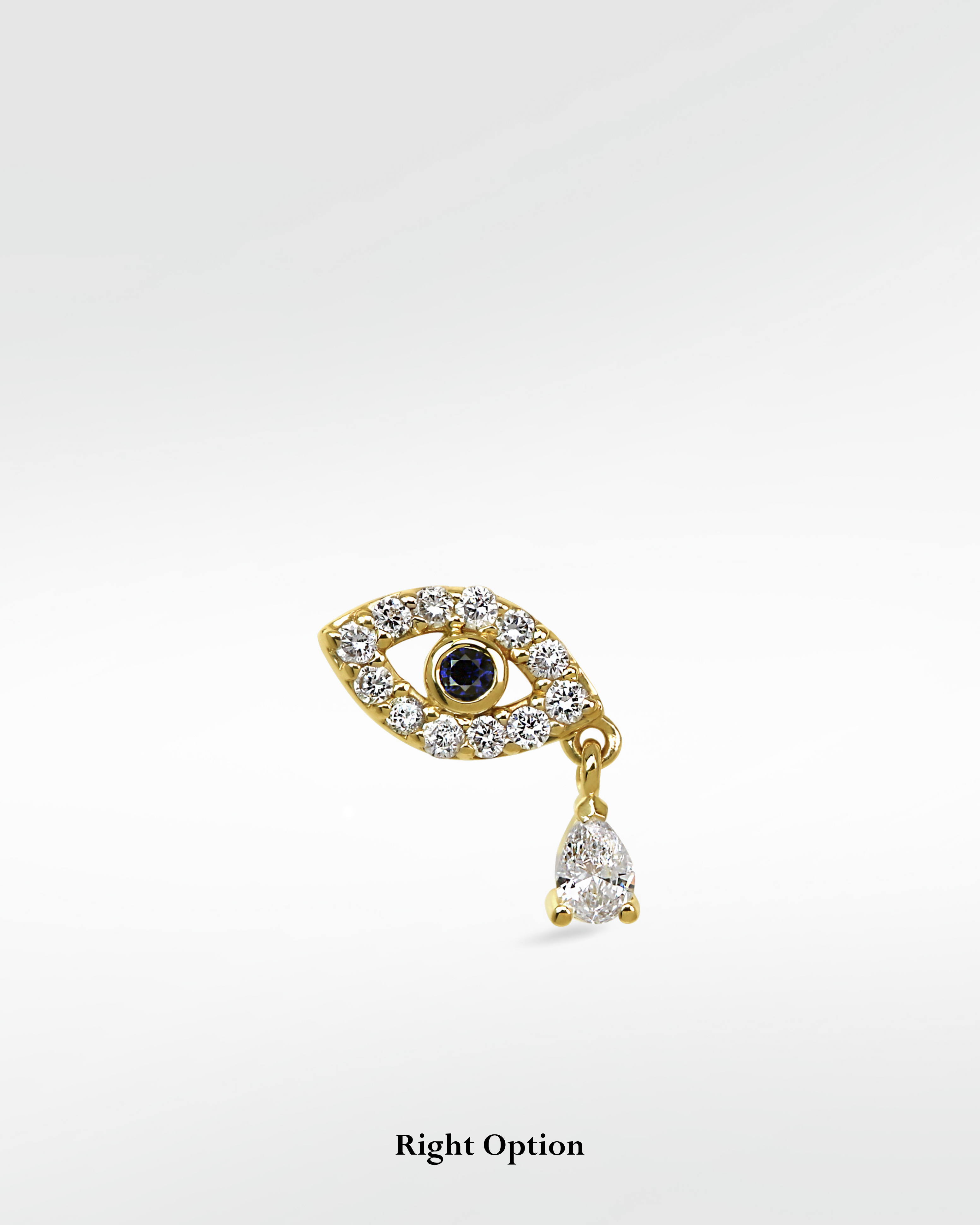 Lark & Berry 14k gold evil eye earring with a blue sapphire, diamond pavé, and a dangling pear-shaped diamond drop.