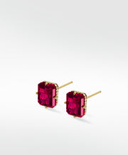 Lark & Berry's London Bridge Ruby Studs featuring emerald-cut rubies and a diamond halo in a yellow gold prong setting.