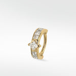 Lark & Berry's Modernist hoop in 14k gold with a central princess cut diamond and channel-set diamond accents.