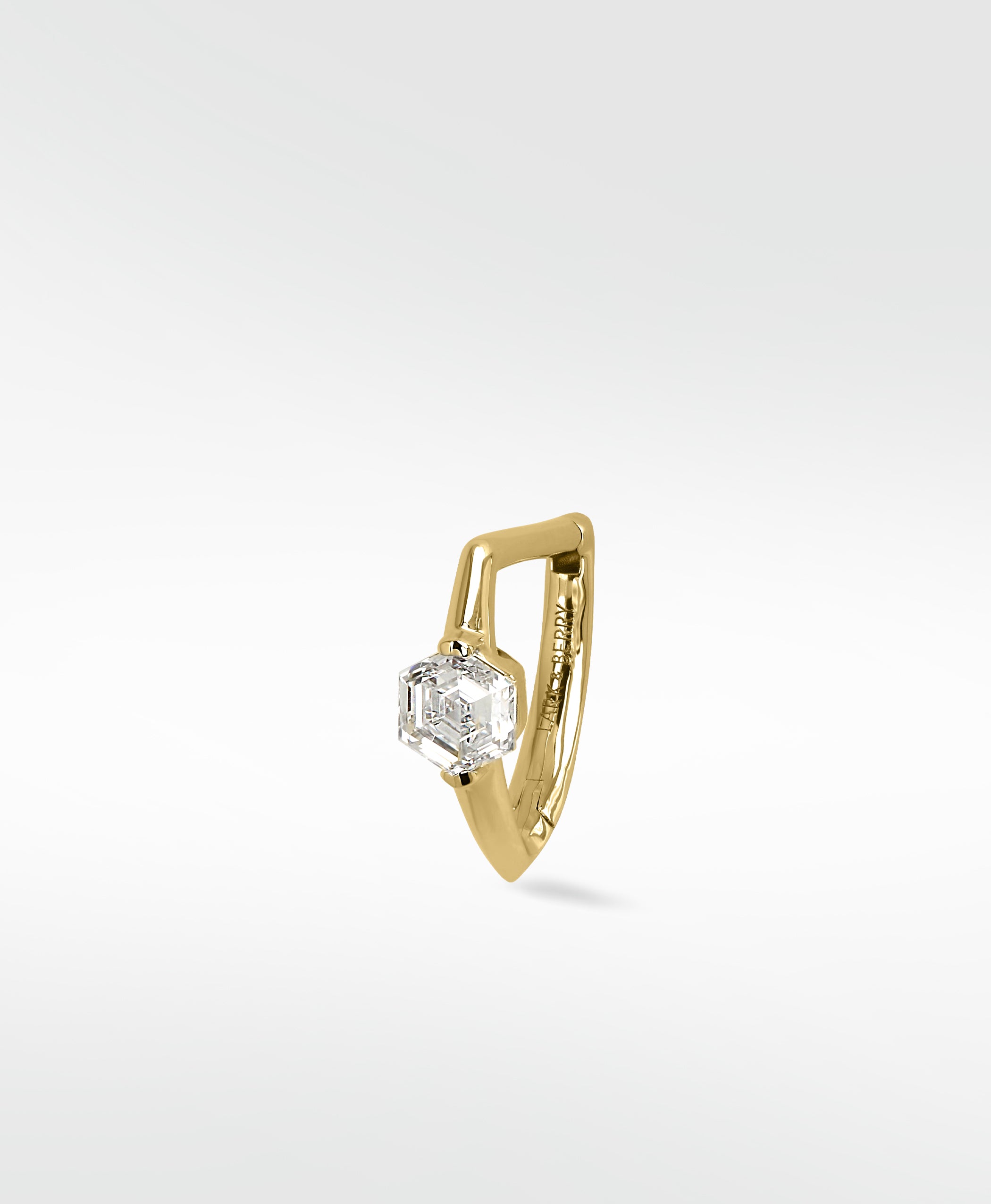 Lark & Berry 14k gold knife-edged hoop earring featuring a brilliant hexagonal-cut diamond on a white background.
